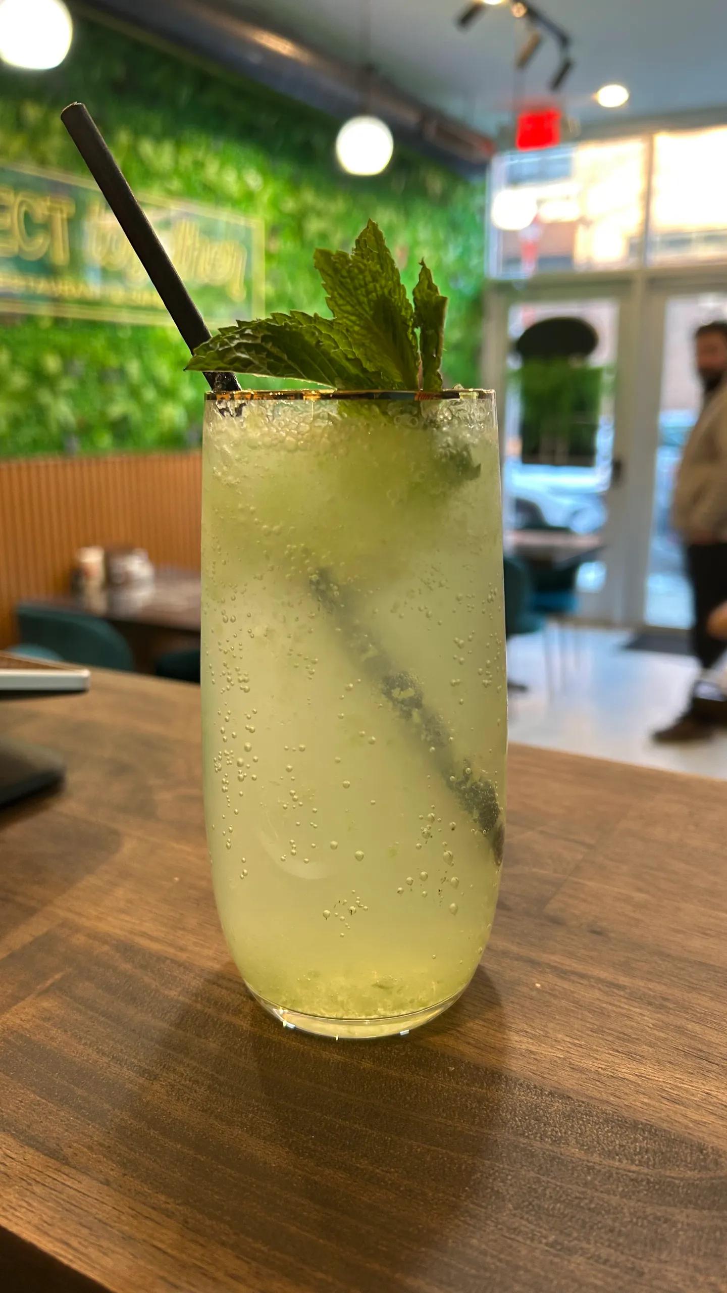 Refreshing cucumber mint lemonade at Perfect Together Restaurant with dining interior Philadelphia